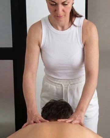 Areti massaging a client's shoulders